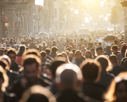 An image of a blurred crowd of unrecognisable people in the street