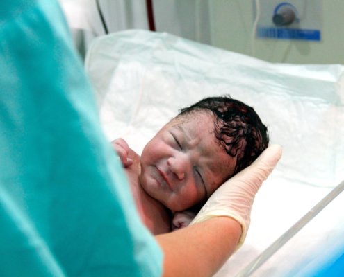 An image of a newborn baby in hospital
