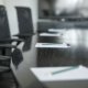 An image of a round table in an empty boardroom